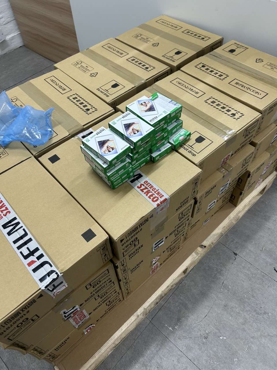 Sealed Fujifilm Instax Mini 10 instant film retail boxes on shipping cartons in Sky City Y2K warehouse