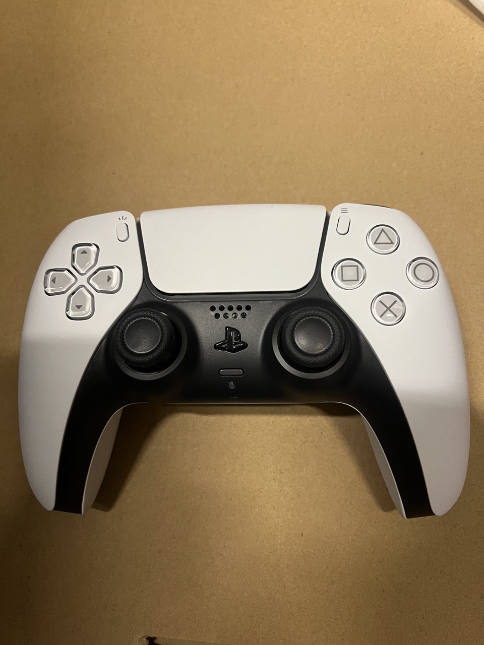 Front view of the white DualSense wireless controller supplied with PS5 Pro